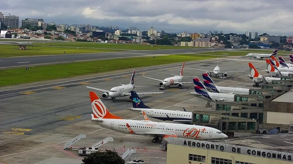 Online view of an airport apron with aircraft at the air bridges and a taxiway